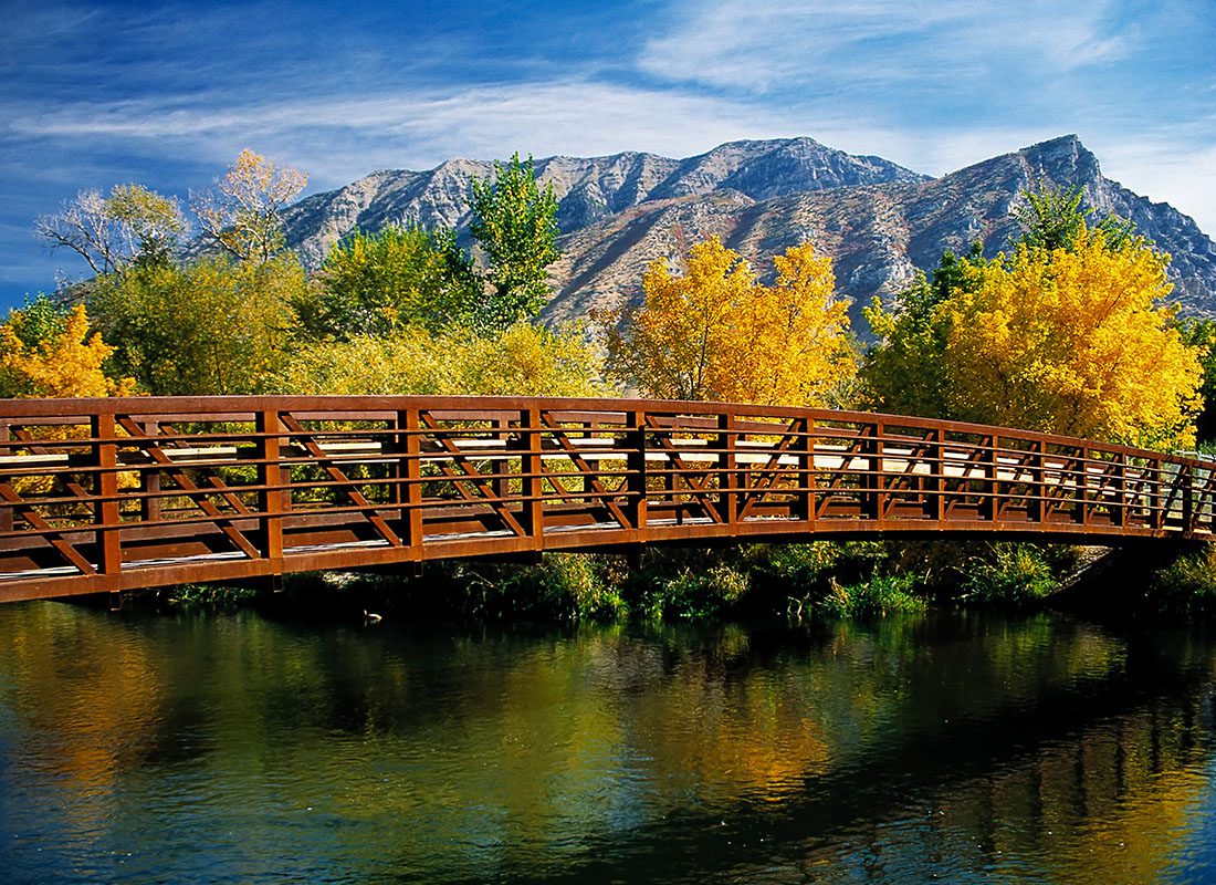 Insurance Solutions - Bridge Crossing Over Provo River With a Mountain Range in the Background